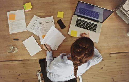 Woman working at desk with laptop